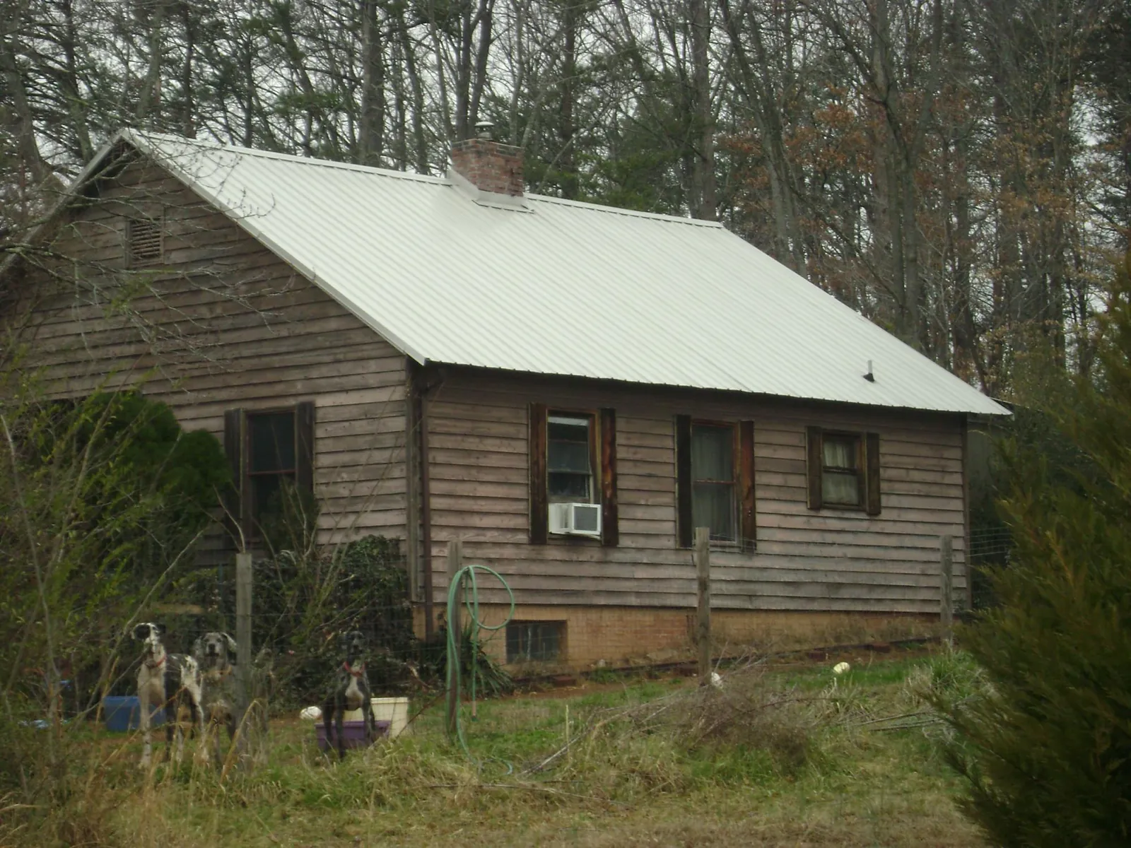White metal roof on an old wood sided farmhouse, from a Metal Roof Installation job in Cardington
